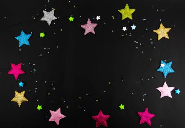A black background with colored stars along the contour with space in the center for design and text