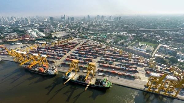 Aerial image of cargo ships at seaport with city view — Stock Photo, Image