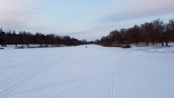 Leć Tyłem Nad Biegami Zamarzniętej Pokrytej Śniegiem Rzece Lopan Wieczornym — Wideo stockowe