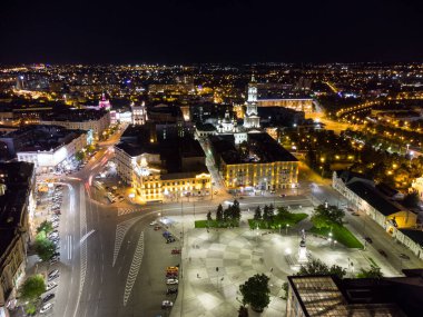 Gece ışıkları şehrin havadan görüntüsünü aydınlatıyordu. Şehir merkezi meydanı (Maidan Konstytutsii) Dormition Katedrali, Ukrayna 'nın Kharkiv kentindeki tarihi müze simgeleri