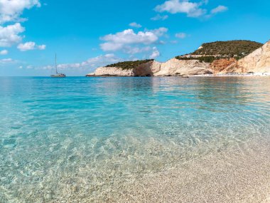 Beyaz mermer Porto Katsiki çakıl taşlı kumsal gelgiti açık mavi suyla. Lefkada adasının kıyılarına yakın, Yunanistan 'da sarp kayalıklar var. İyon Denizi 'ne yaz tatili