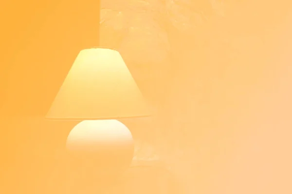 Bedside orange color graded illuminated lampshade light lamp with round base Interior design elements stylish background