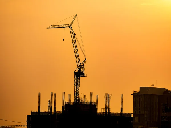 Silhouette di costruzione gru sul cielo tramonto — Foto Stock