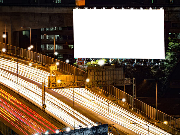 blank billboard in the night time for advertisement. long exposure makes long street light tails.