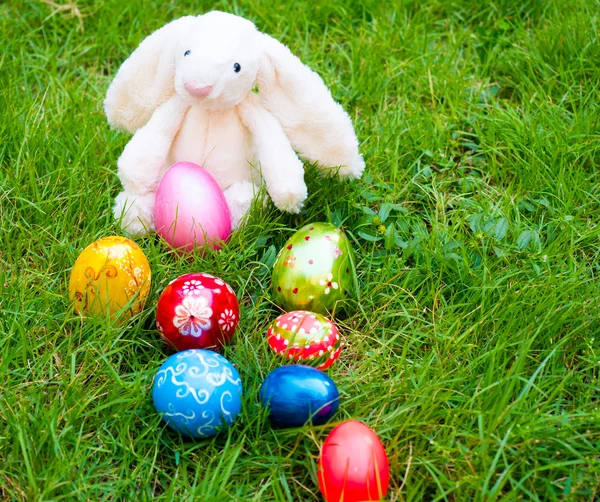 Colorful easter eggs on a grass with bunny — Stock Photo, Image
