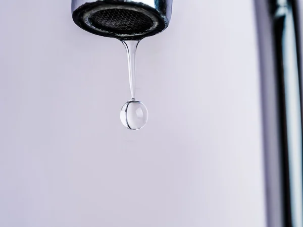 Close up shot on water drop from faucet — Stock Photo, Image