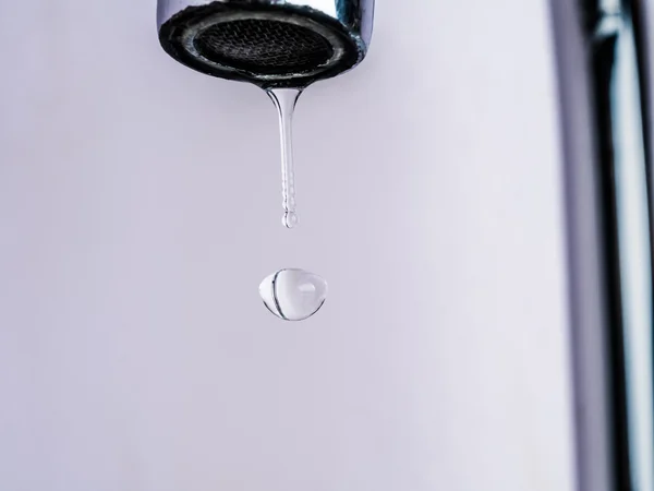 Close up shot on water drop from faucet — Stock Photo, Image