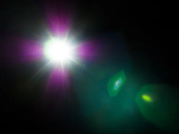 Lens flare of strong light source in the dark — Stock Photo, Image