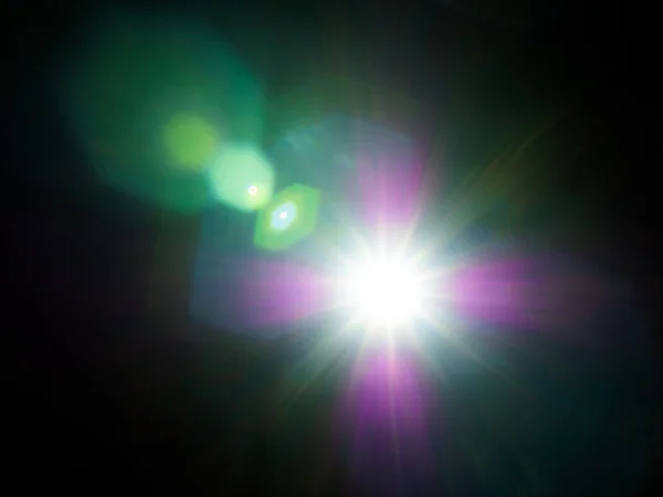 Lens flare of strong light source in the dark — Stock Photo, Image