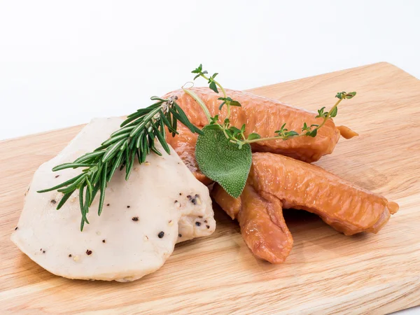 Boiled chicken wings and meat placed on wooden background — Stock Photo, Image