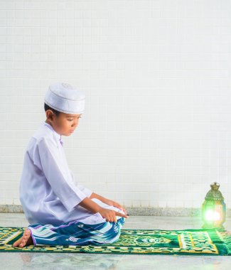 Muslim child worships and prays for Allah clipart