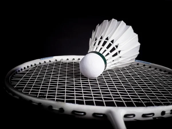Racket with string and shuttlecock on black background — Stock Photo, Image