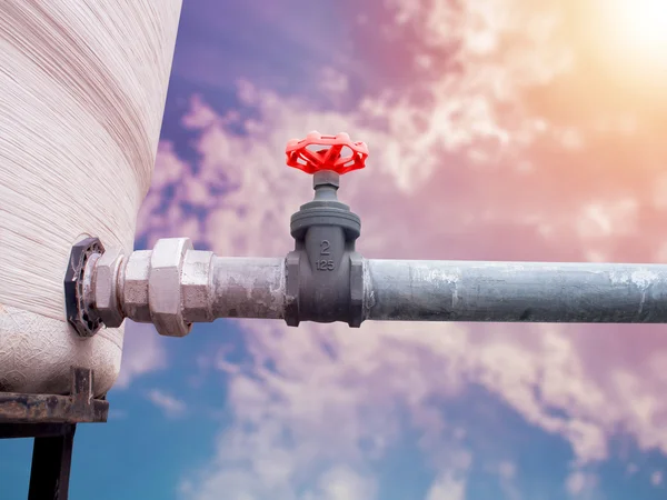 Water steel pipe and valve in service on colorful sky — Stock Photo, Image