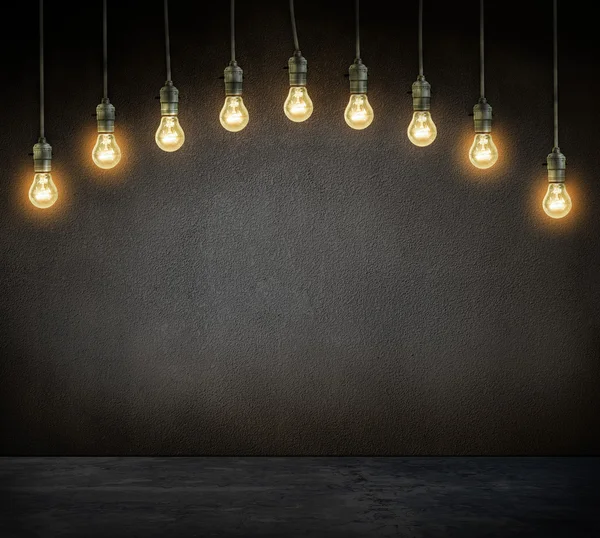 Electrical incandescent lamp glowing on dark — Stock Photo, Image