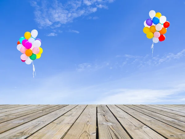 Ballons wooden floor and sky — Stock Photo, Image
