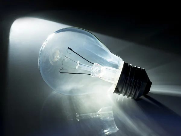 Incandescent light bulb in black — Stock Photo, Image