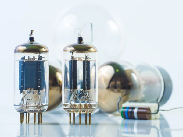 Vacuum tube and incandescence bulb on white — Stock Photo, Image