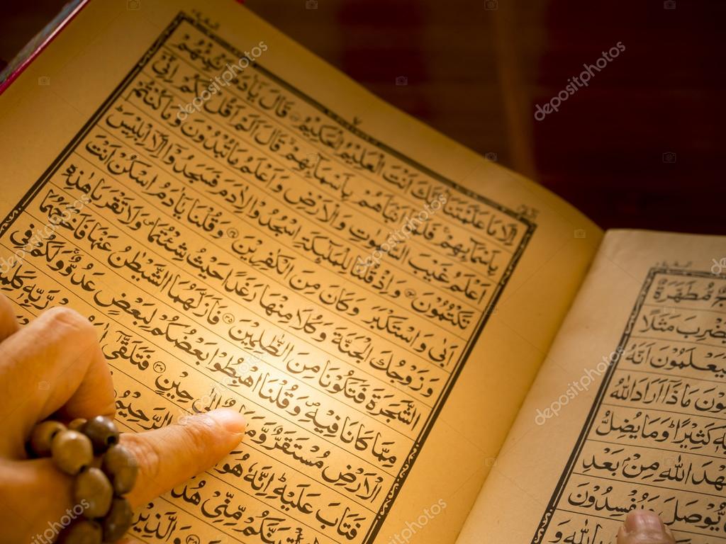 Рука мусульманина читает Коран, священную книгу — Стоковое