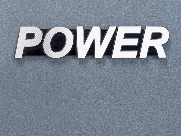 Kovové slovo "Power" na šedém pozadí — Stock fotografie