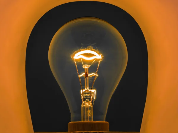 Glowing light bulb by electrical current — Stock Photo, Image