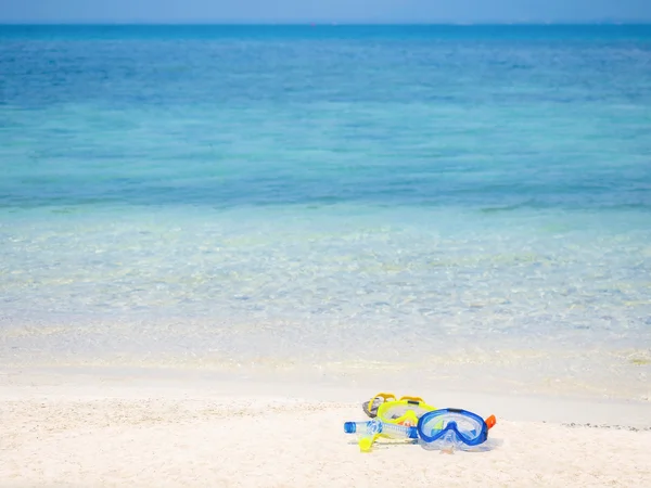 dive equipment on white sand beach