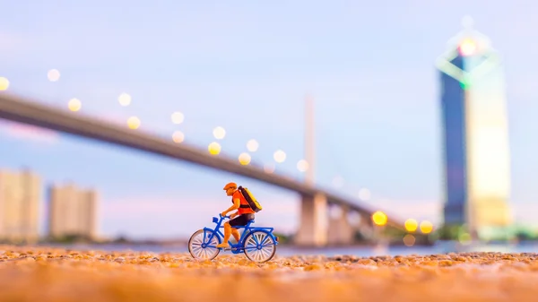 Plastic toy standing in front of the river — Stockfoto