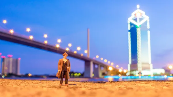Plastic toy standing in front of the river — Stockfoto