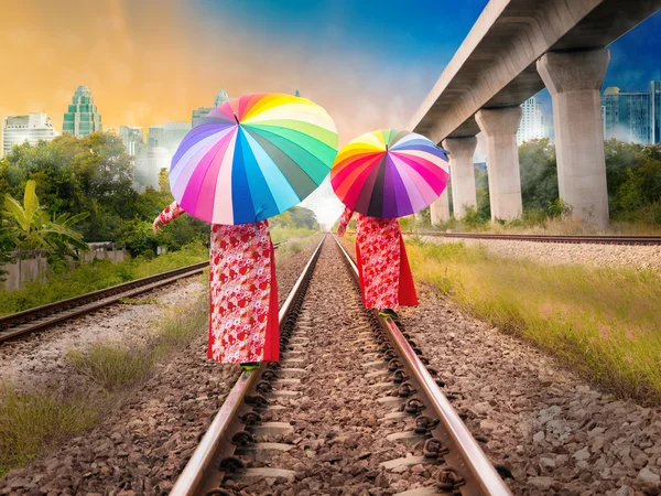 Woman walking on the rail road to the big city — Stock Photo, Image