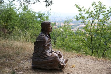 San Damiano kilisesinin yakınındaki Aziz Francis heykeli.