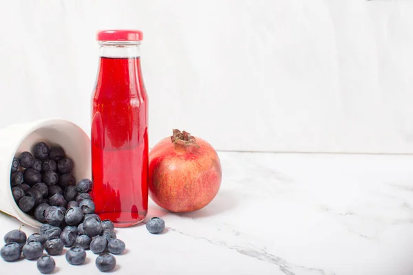 Fresh Pomegranate Glass Bottle Gray Background Pomegranate Blueberries — Stock Photo, Image