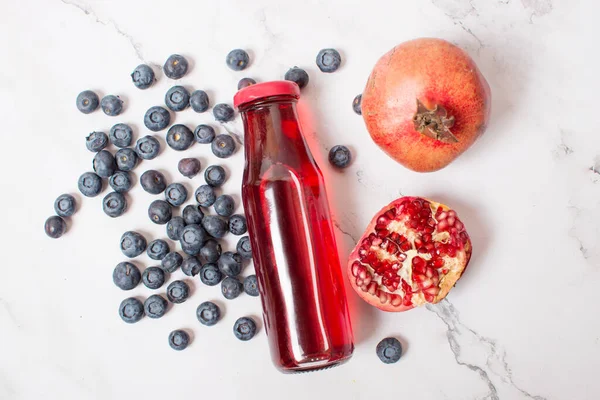 Fresh Pomegranate Glass Bottle Gray Background Pomegranate Blueberries — Stock Photo, Image