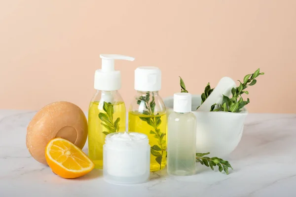 Homemade skin care and body scrub with natural ingredients lemon slice ,aromatic oils and mangosteen body scrubs set up on white wooden background with flat lay.