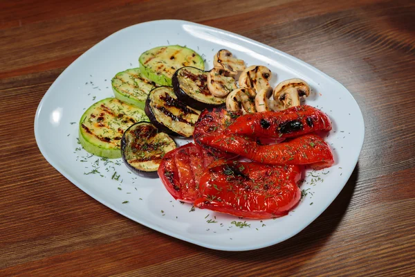 Tasty assorted grilled vegetables on a white plate.