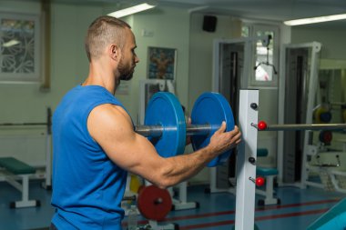 Vücut geliştirme dumbbells ile. Husky büyük bir dumbbell elinde tutar. Spor, vücut geliştirme, sağlıklı yaşam tarzı.