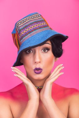 Güzel, parlak yaratıcı makyaj kız. Komik bir şapka esmer. Kızın duygusal, canlı görüntü.