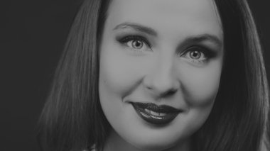 Karanlık bir arka plan üzerinde bir şık elbiseli seksi esmer.