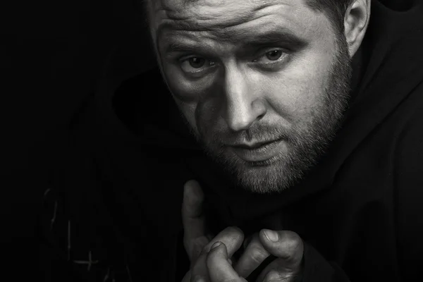 Beautiful and fascinating game theater actor on camera. Black and white photo of the actor in the guise of a beggar on a dark background. Beautifully decorated stage image and professional makeup.