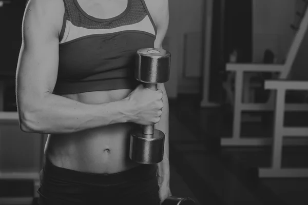 Sportschool vrouw push-up sterkte pushup oefenen met dumbbell in een fitnesstraining. Atletische jonge vrouw doen oefeningen. — Stockfoto