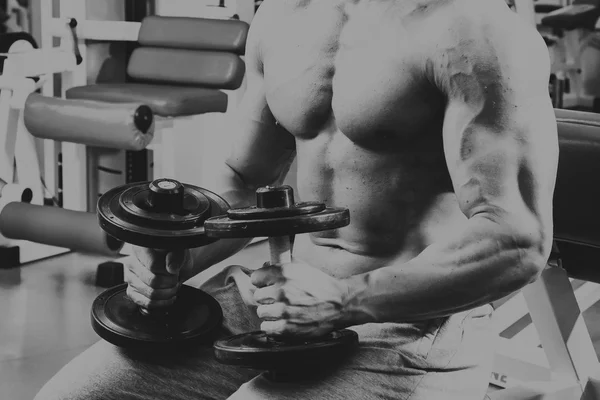 Hombre en el gimnasio. El hombre hace ejercicios con barra . — Foto de Stock