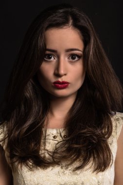 Karanlık bir arka plan üzerinde güzel genç esmer. Seksi seksi esmer. Lüks kadın şık makyaj ile.