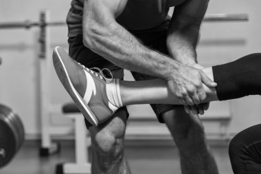 Genç çift müşterek eğitim oturumunda jimnastik salonu. Karşılıklı yardım çalışmaları taşıyan. Uygun egzersiz. Fotoğraflar sportif ve sosyal dergiler, posterler ve Web siteleri için.