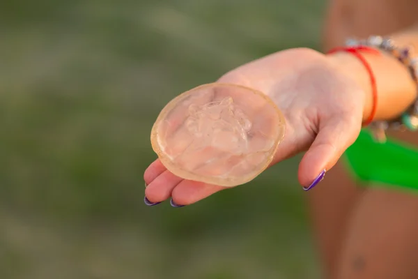 Mädchen hält sich an lodoshke kleine Quallen. Sommer, die schöne Natur, angenehmer Urlaub. — Stockfoto