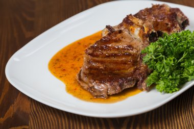 Dana rosto bir tabakta sebze ile bir tavada.