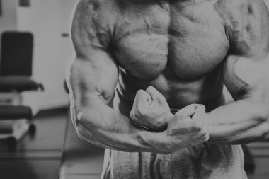 Spor salonunda yakışıklı, atletik, kendine güvenen adam. vücut geliştirme poz