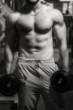 Adam jimnastik salonu. Egzersiz halter kılıyor. Spor, güç, halter, gerginlik, egzersiz - sağlıklı bir yaşam tarzı kavramı. Fitness ve spor hakkında makale.