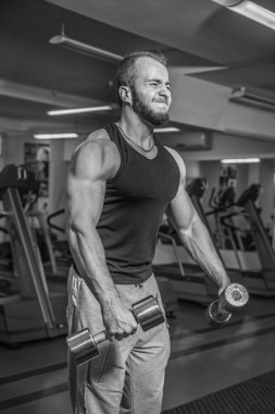 Adam jimnastik salonu. Egzersiz halter kılıyor. Spor, güç, halter, gerginlik, egzersiz - sağlıklı bir yaşam tarzı kavramı. Fitness ve spor hakkında makale.