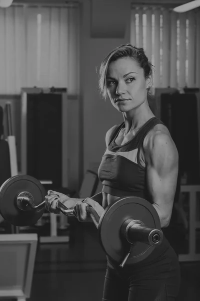 Chica bombea los principales grupos musculares en el gimnasio. Entrenamiento de fuerza. Aptitud femenina. Chica fuerte . — Foto de Stock