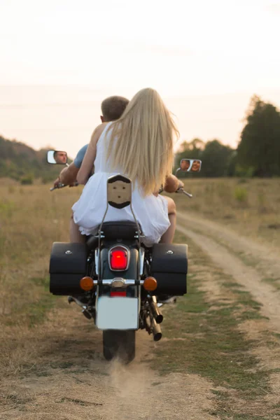 Jeune couple romantique dans un domaine sur une moto — Photo