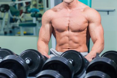 Spor salonunda yakışıklı, atletik, kendine güvenen adam. vücut geliştirme poz