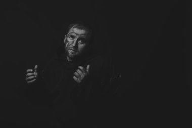 Güzel ve büyüleyici oyun tiyatro aktör kamera. Siyah ve beyaz fotoğraf aktör karanlık bir arka plan üzerinde bir dilenci kılığında. Dekore edilmiş sahne görüntü ve profesyonel makyaj.